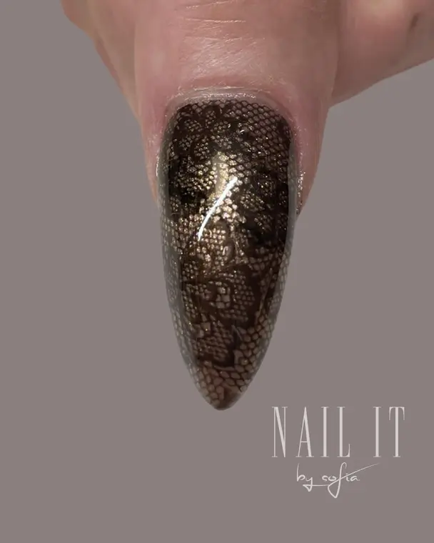 Svart och guld nail art med spetsmönster